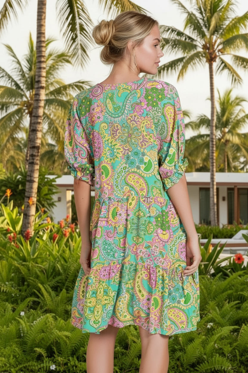 Woman wearing a colorful patterned dress in a minimalistic setting