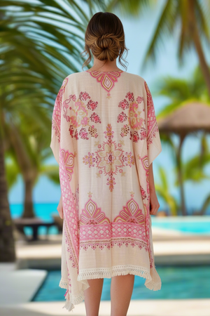 Woman wearing a floral kimono in a tropical setting with palm trees and a pool.