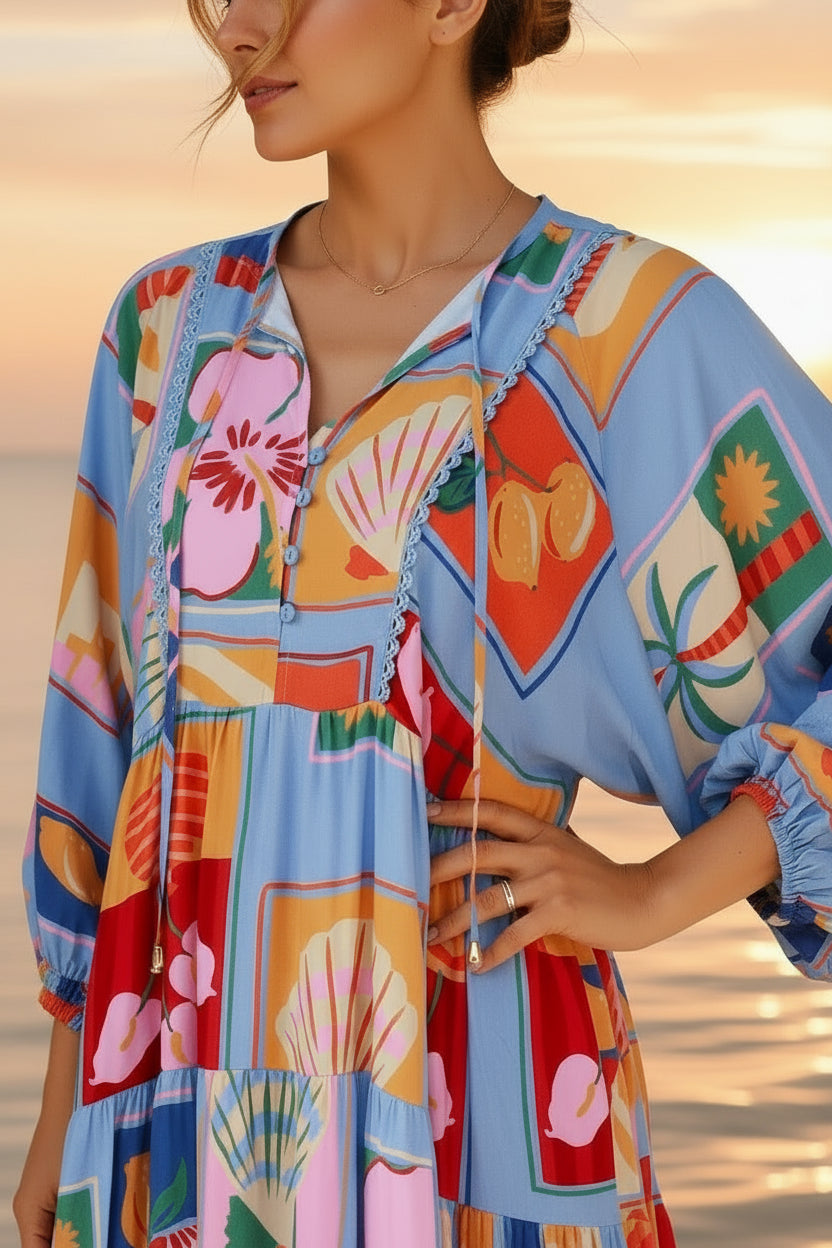 Colorful patterned dress worn by a person with a sunset and water background