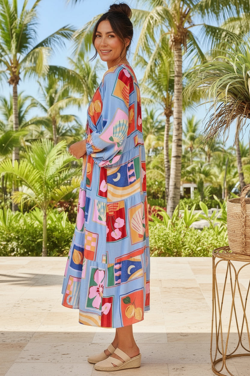 Woman in a colorful dress standing in a tropical setting with palm trees.