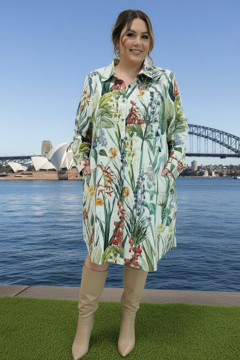 Woman in a floral corduroy shirt dress with Sydney harbour in the background