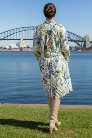 Person wearing a floral shirt dress with a bridge and Opera House in the background