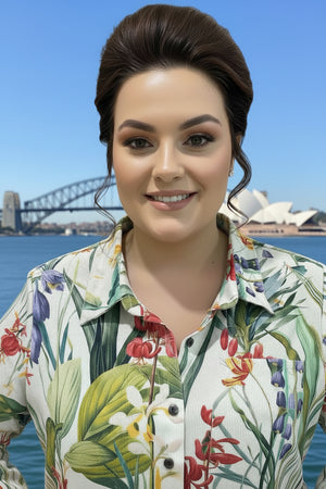 Woman wearing a floral shirt dress with a bridge and Opera House in the background