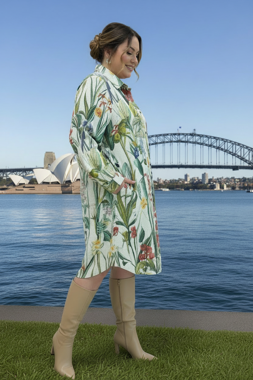 Woman in a floral corduroy shirt dress with Sydney harbour in the background