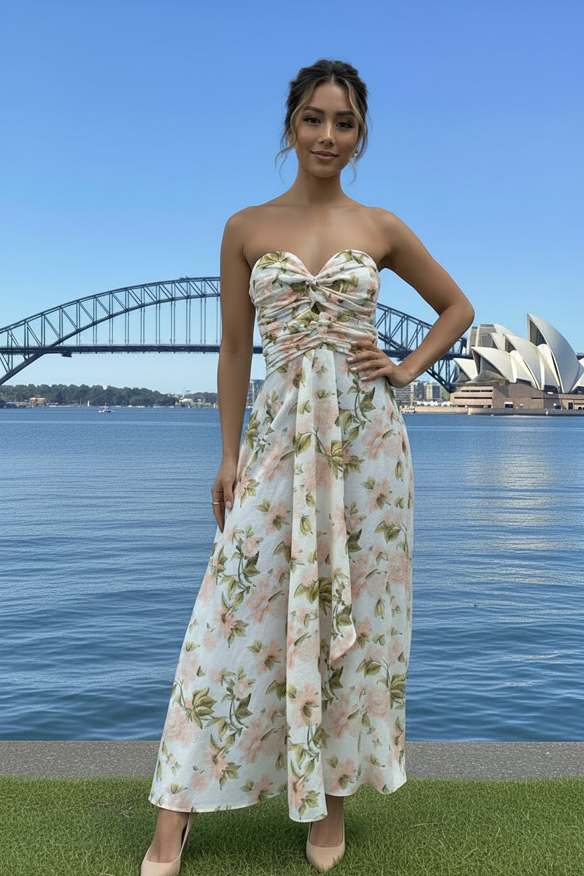 Woman in a floral dress standing in front of the Sydney Harbour Bridge and Opera House.