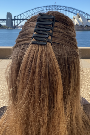 Person with long hair tied back with a black Claw Combo Hair Pin