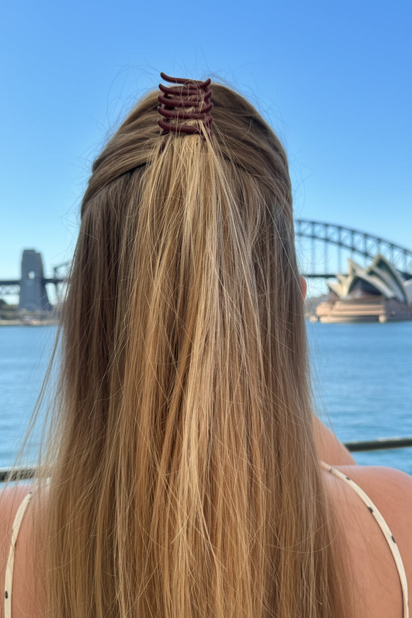Person with long hair and a green hair clip 