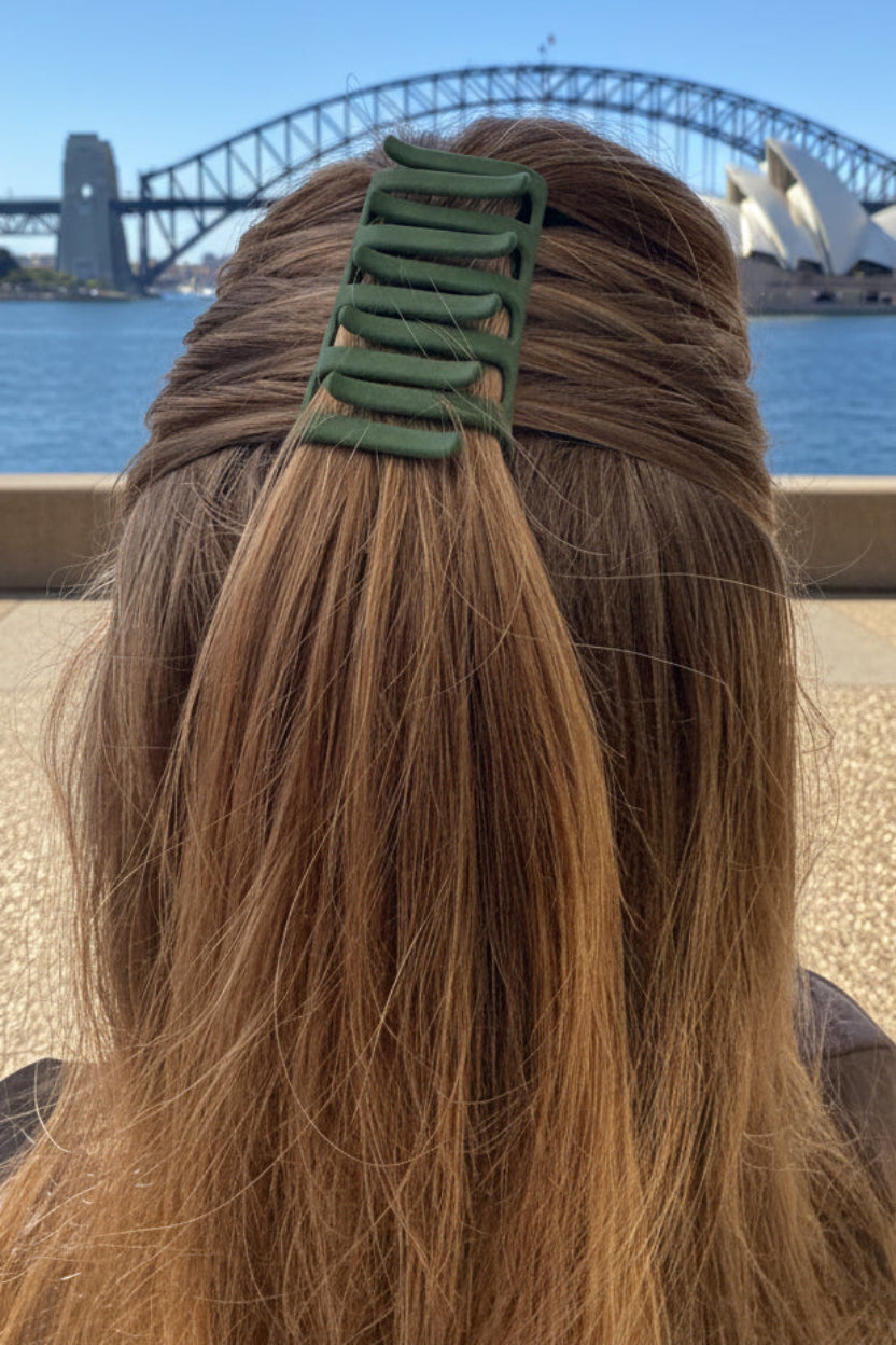 Person with long hair and a green hair clip 