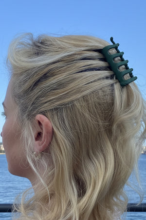 Person with blonde hair featuring a green Claw Combo Hair Pin