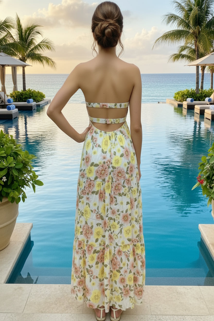 Woman in a floral dress standing by a pool with palm trees in the background