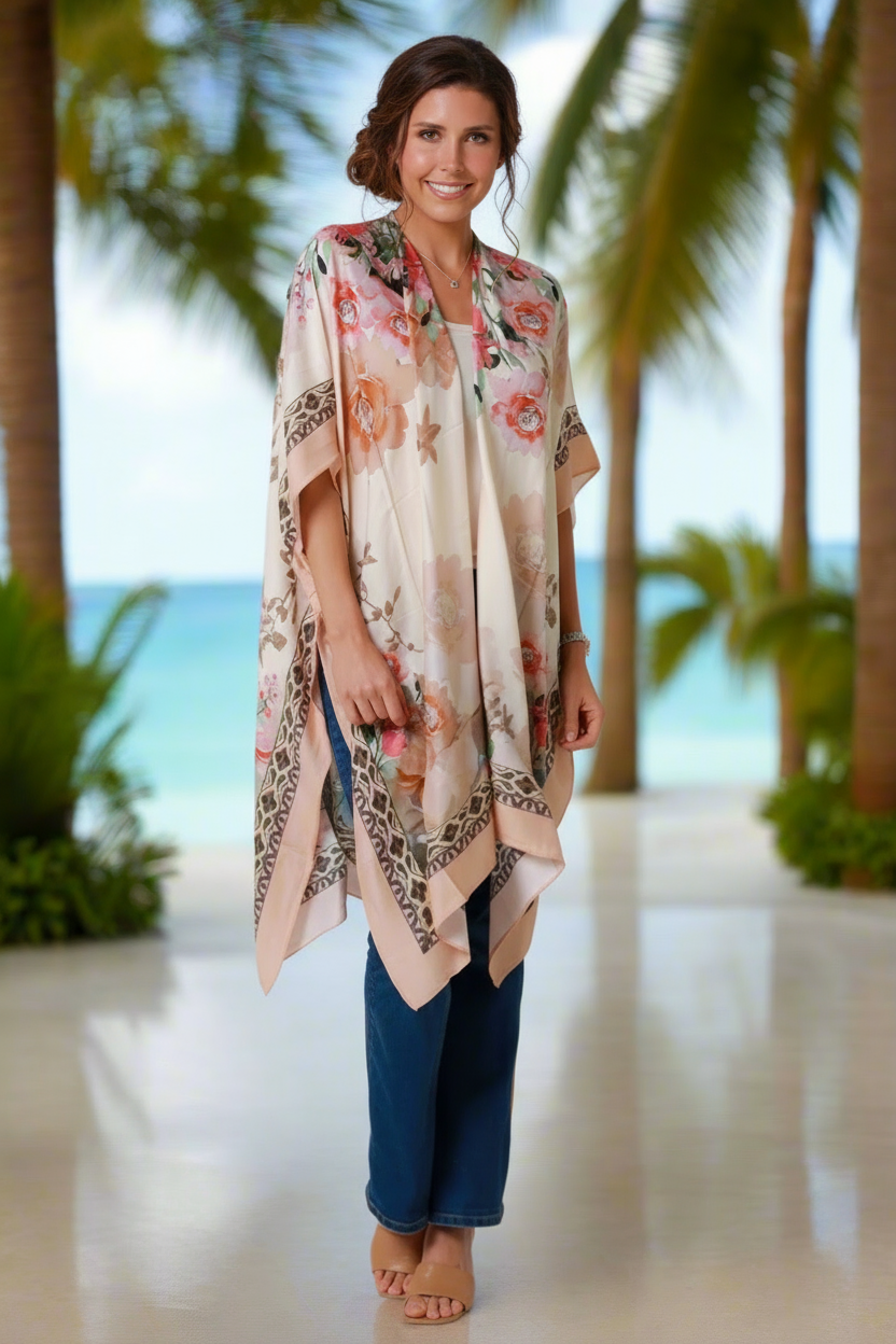 Woman wearing a floral kimono-style garment with palm trees and ocean in the background