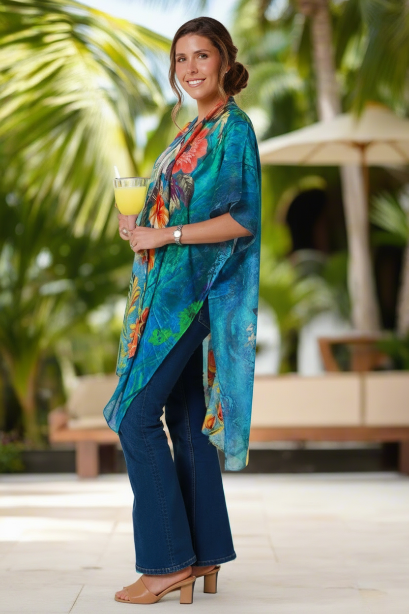 Woman in a colorful kimono-style garment standing outdoors with palm trees in the background