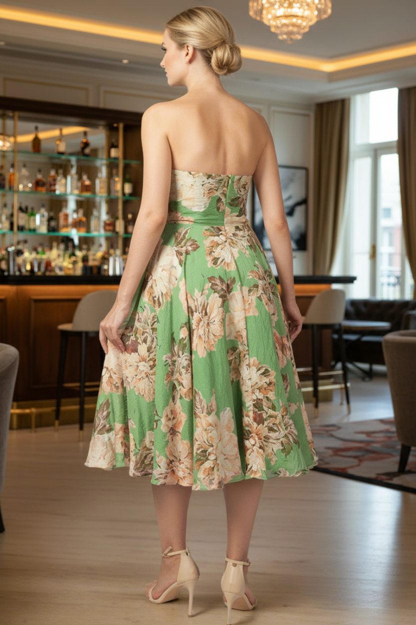 Woman wearing a green strapless midi floral dress in a bar setting