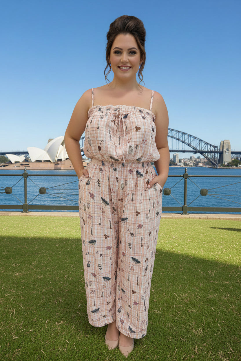 Woman in a patterned Jumpsuit standing in front of the Sydney Harbour Bridge.