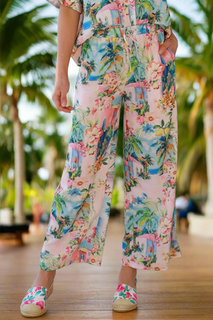 Person wearing a colorful floral outfit with a blurred background