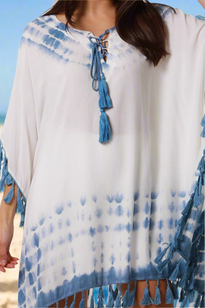 White and blue tie-dye cover-up with tassels on a blurred background