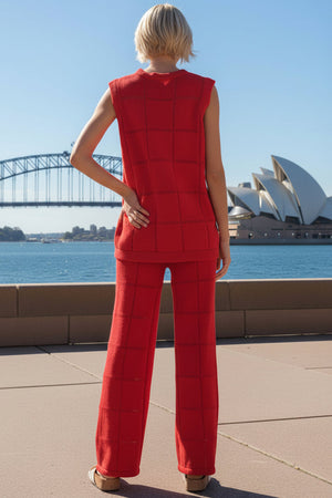 back view of a woman wearing a red outfit with a quilted pattern, standing in front of the Sydney Opera House and Harbour Bridge.