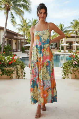 Woman in a colorful floral dress standing by a pool with palm trees and flowers in the background