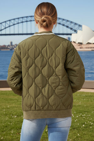 Person wearing a quilted green jacket