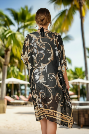 Woman wearing a floral patterned cover-up in a tropical setting with palm trees and beach umbrellas.