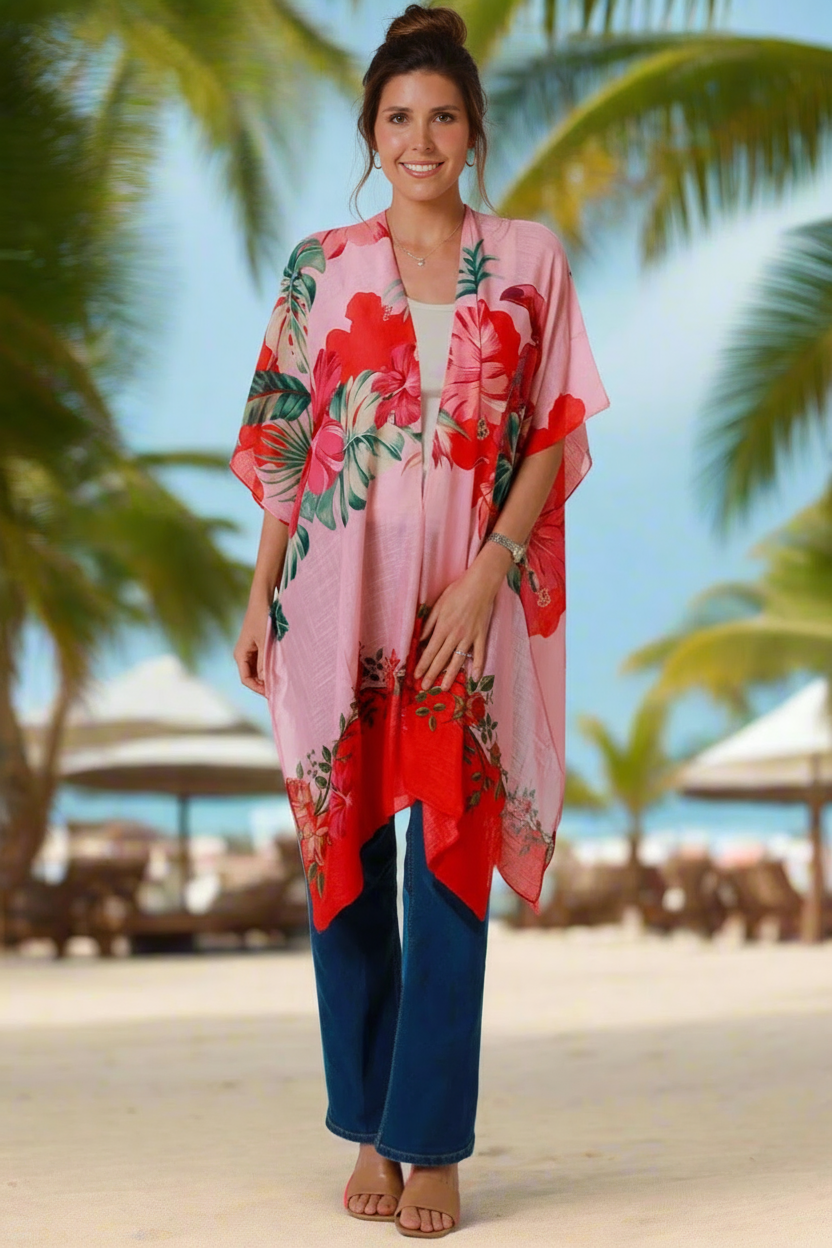 Woman wearing a floral kimono on a beach with palm trees in the background
