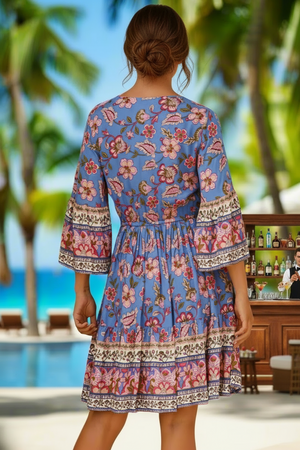 Woman wearing a floral dress with a tropical background