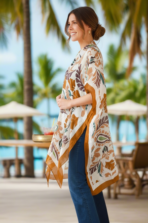 Woman wearing a floral kimono-style garment with palm trees and a beach setting in the background