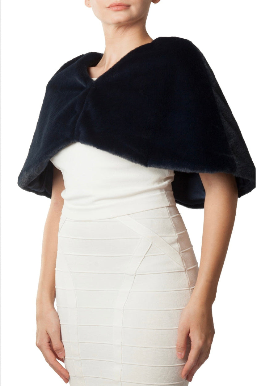 Woman wearing a navy blue shawl over a white dress