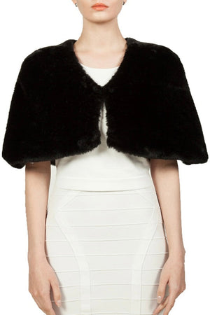 Black faux fur shrug over a white dress