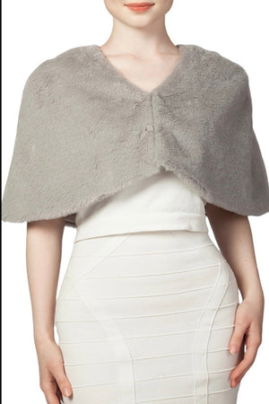Gray faux fur shawl over a white dress 