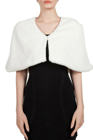 White faux fur cape over a black dress 