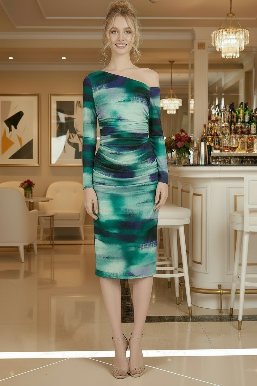 Woman wearing a green and blue one-shoulder dress in an elegant indoor setting.