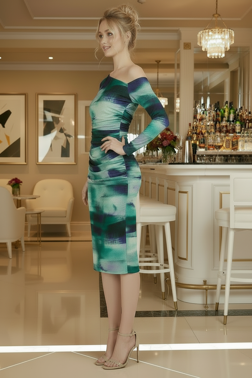Woman wearing a green and blue one-shoulder dress in an elegant indoor setting.
