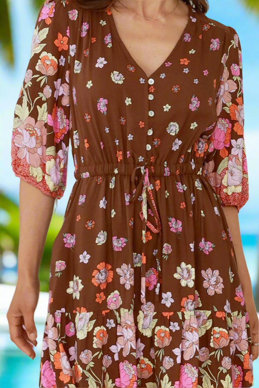 Brown floral dress with a blurred natural background