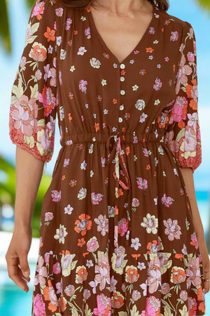 Brown floral dress with a blurred natural background