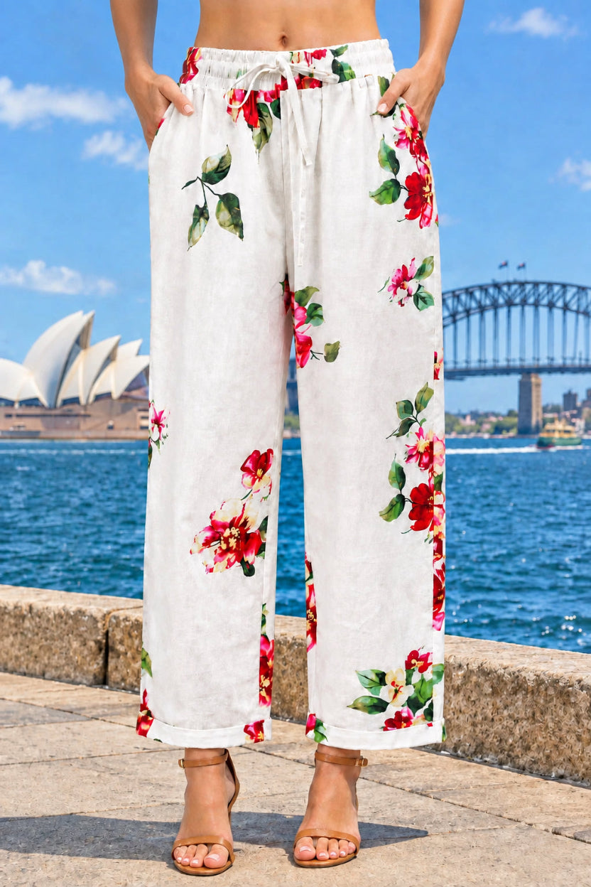 Light pink cotton cropped pants with side pockets with a red and green floral print