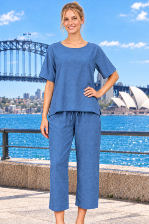A woman wearing a cotton two-piece set in a steel blue colour