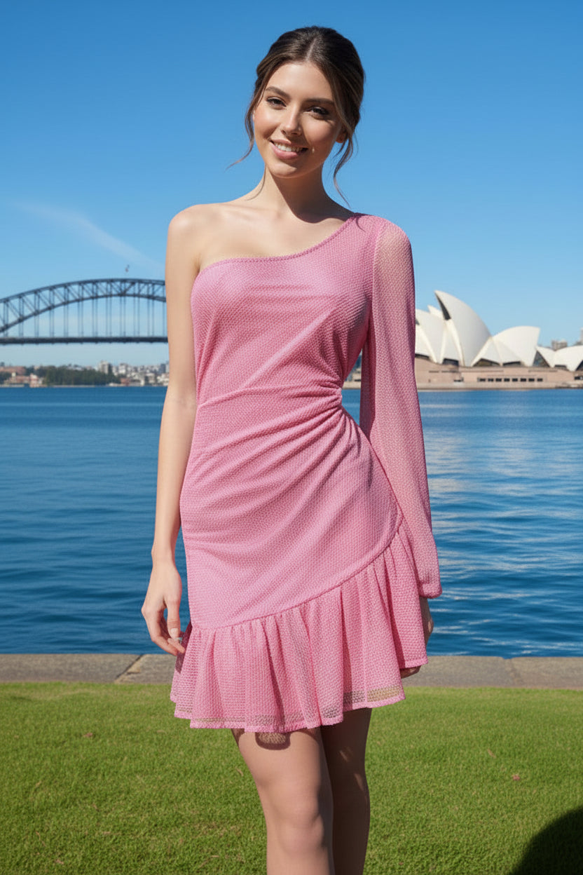 Woman in a pink net dress standing in front of the Sydney Harbour Bridge and Opera House.