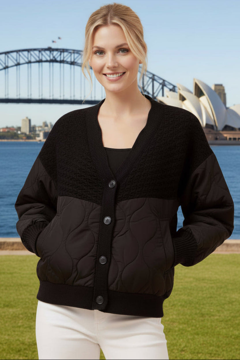Woman wearing a light gray quilted cardigan 