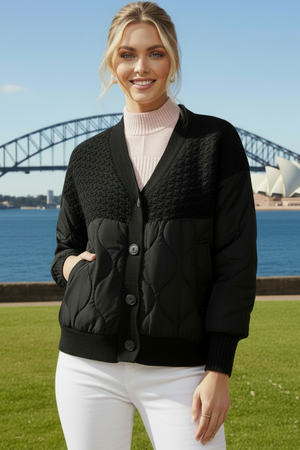Woman in a black jacket and white pants 