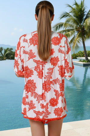 Person wearing a red floral dress on a plain background