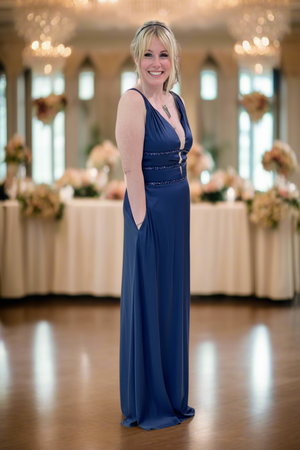 Woman in a blue evening gown standing in a banquet hall.